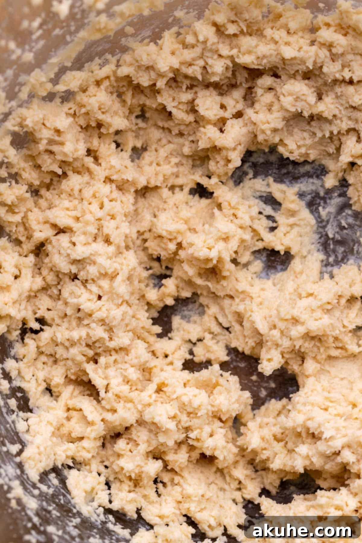 Decadent Cookie Dough Brownies 8 A bowl containing wet ingredients for cookie dough, showcasing a smooth, creamy texture.