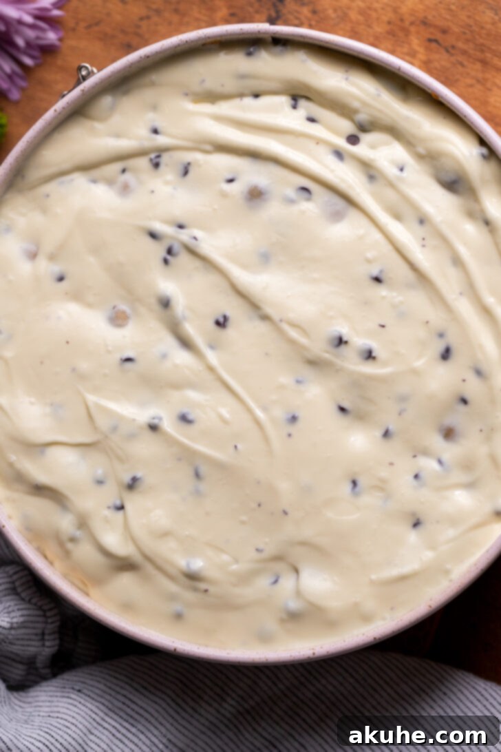 Cheesecake batter poured evenly over the cookie crust in a springform pan.