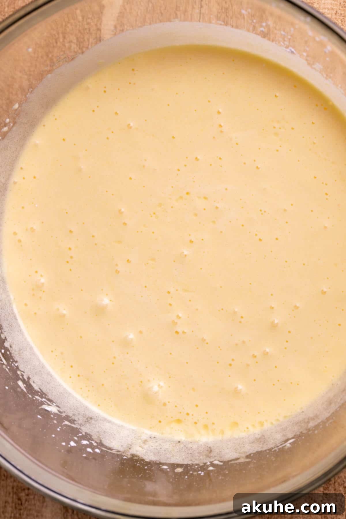 Decadent Cheesecake Brownies 5 Whipped mixture of sugar and eggs in a glass bowl, light and fluffy.