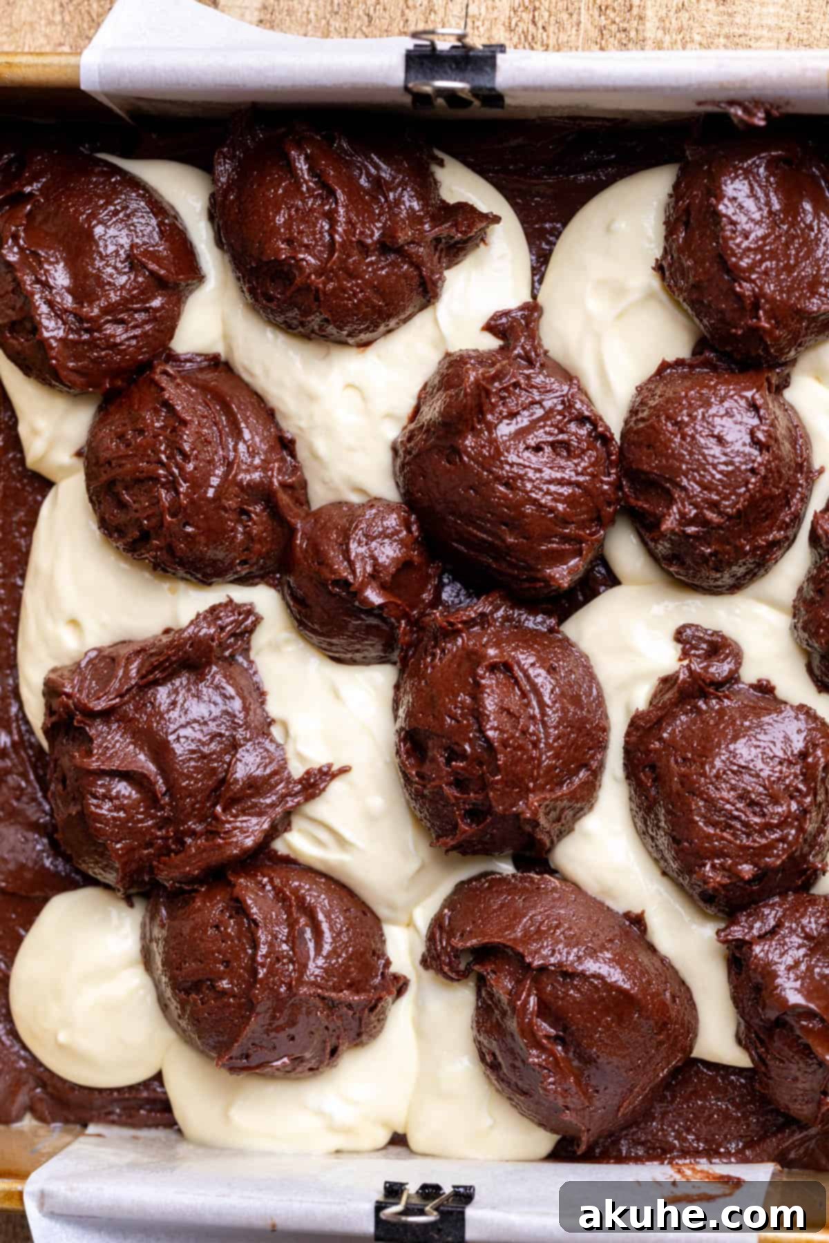 Decadent Cheesecake Brownies 9 More brownie batter dollops strategically placed atop the cheesecake layer.