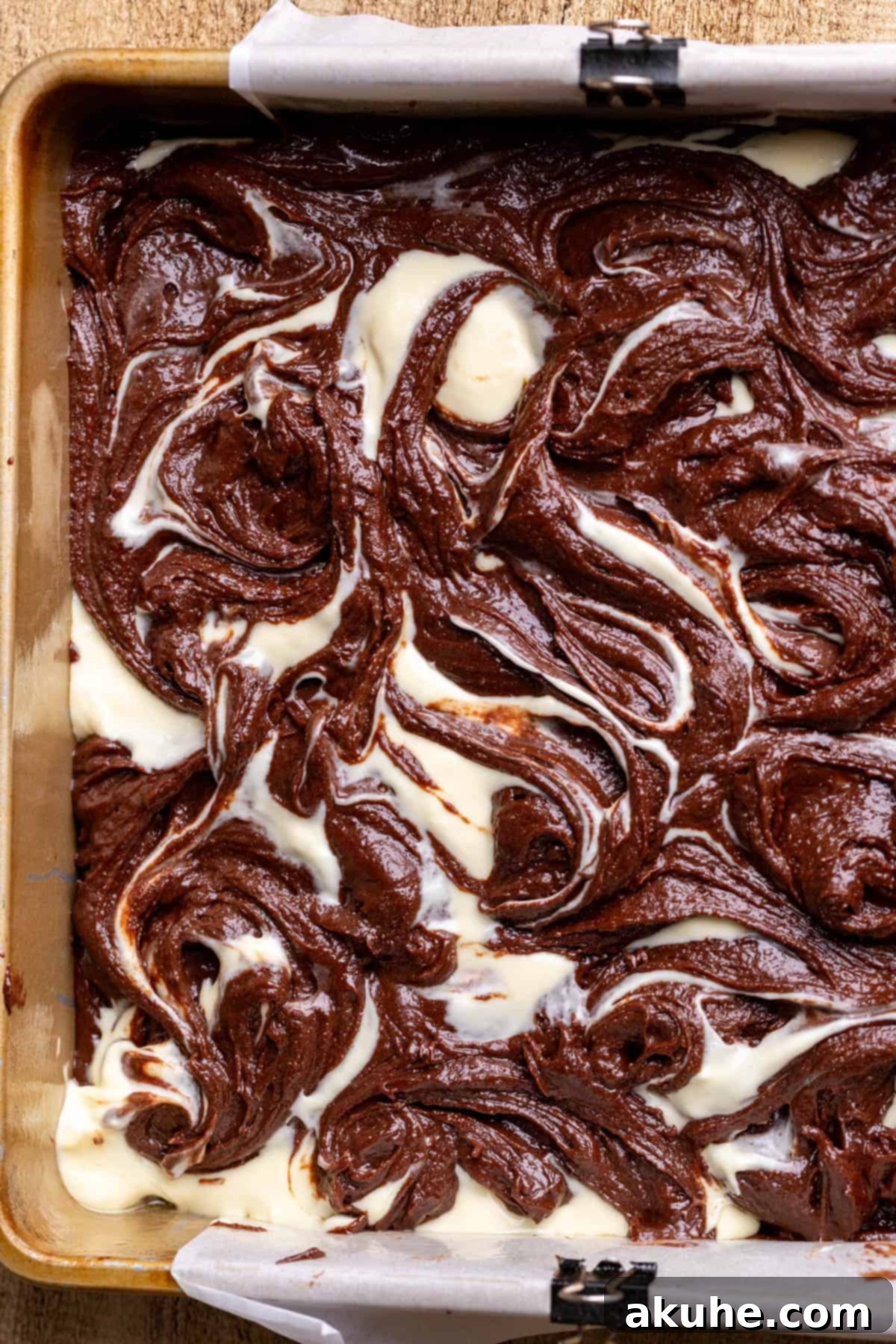 Decadent Cheesecake Brownies 10 Beautifully swirled brownie and cheesecake batter in a pan, ready for baking.