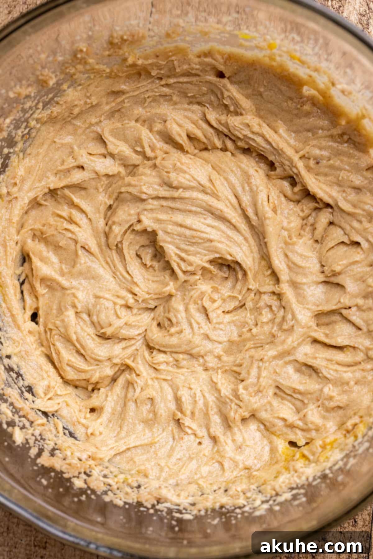 Wet ingredients (brown butter, sugars, vanilla, eggs) in a mixing bowl, ready to be combined.