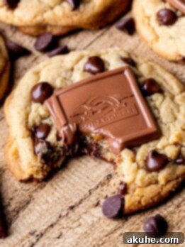 A delicious chocolate caramel cookie with a bite taken out, showing the melted caramel inside.