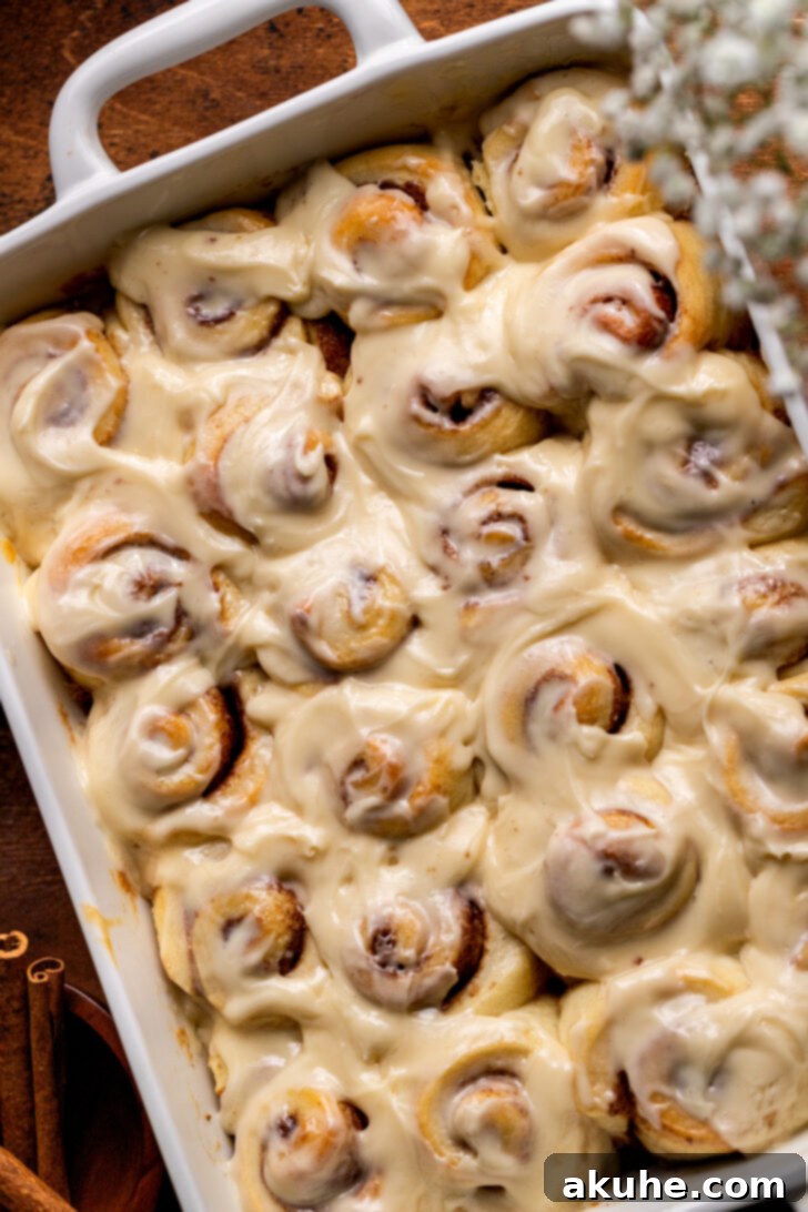 Top view of mini cinnamon rolls, fresh from the oven and glazed.