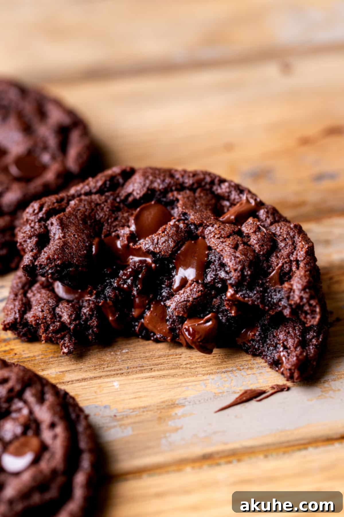 Fudgy Chocolate Delights 2 Stack of one chocolate fudge cookie split in half, revealing the gooey ganache center.