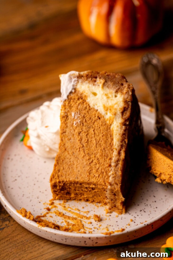 A slice of pumpkin cheesecake on a plate with a bite taken out, inviting a taste.