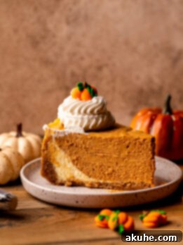 One slice of pumpkin cheesecake on a plate.