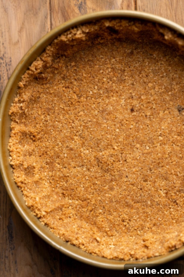 Graham cracker crumbs mixed with butter and sugar, pressed into a springform pan.