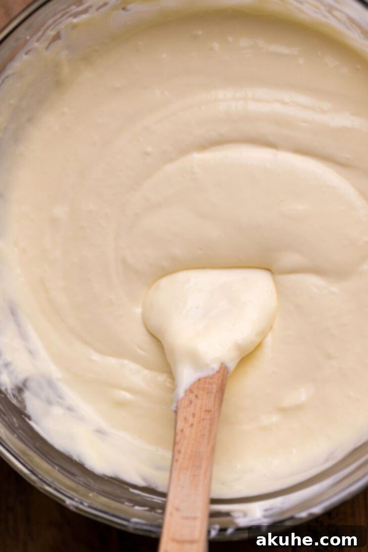 Creamy cheesecake batter in a mixing bowl.
