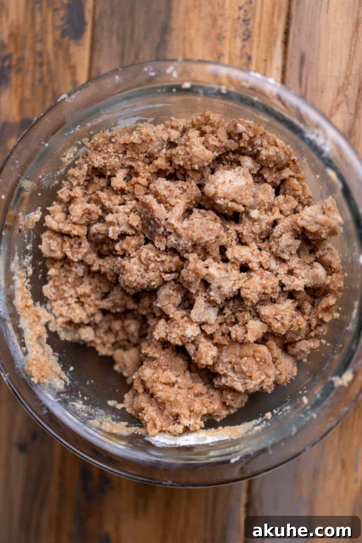 Golden Apple Puff Tart 5 Crumbly streusel mixture in a glass bowl, ready to be sprinkled over the apple tart.