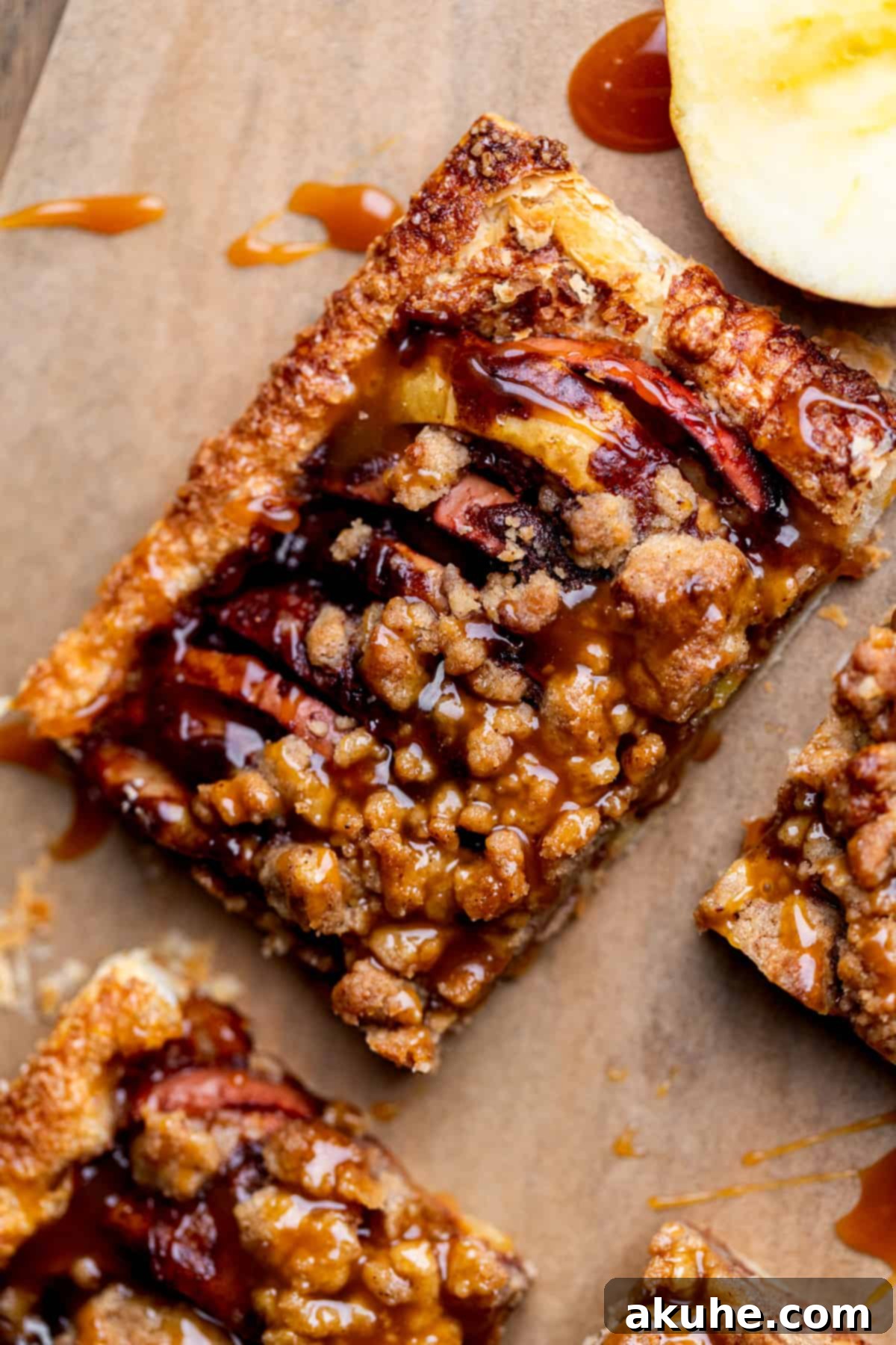 Golden Apple Puff Tart 9 A single, perfectly cut slice of puff pastry apple tart, showcasing the crisp edges, tender apples, and streusel topping.