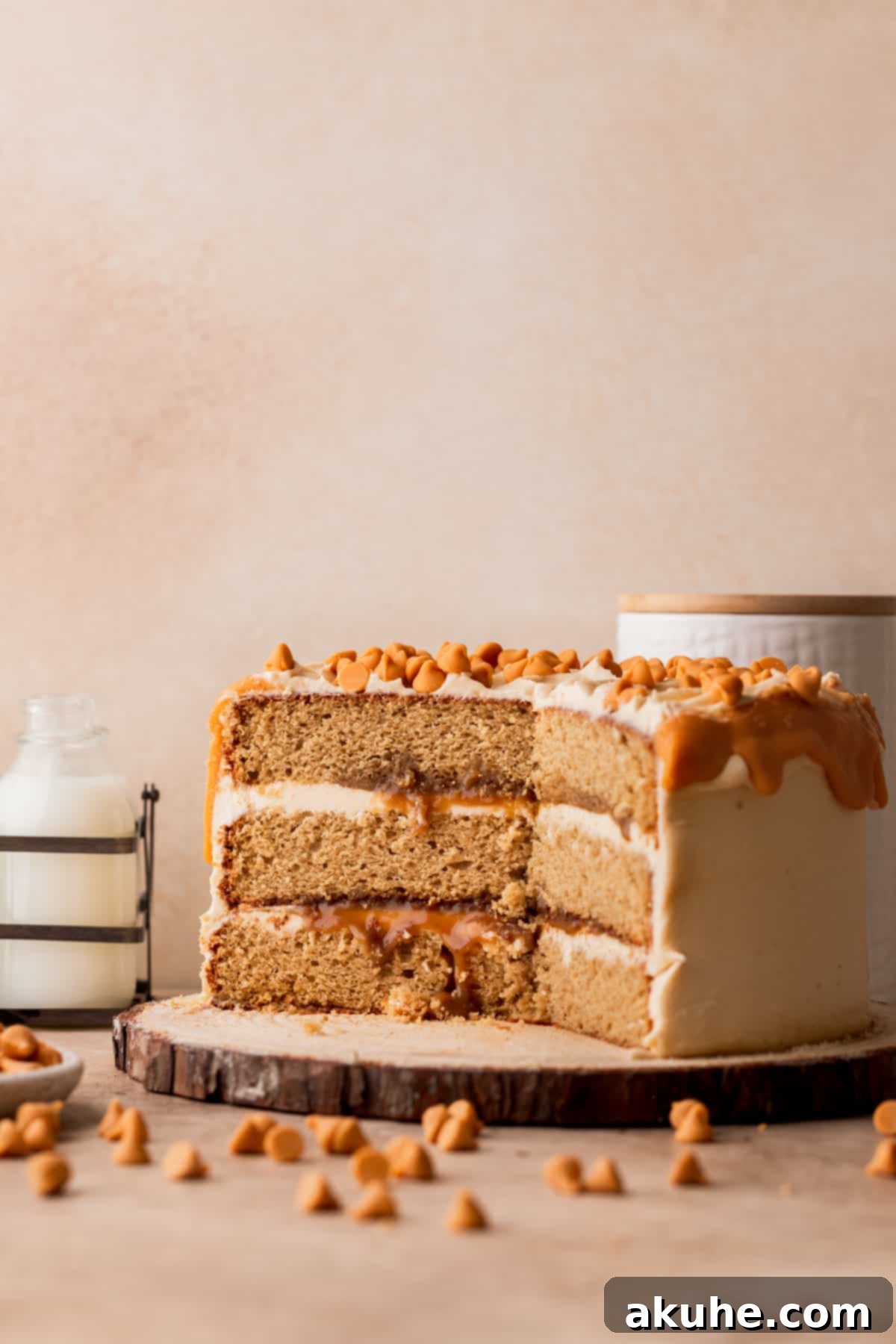 Rich Butterscotch Bliss 2 Butterscotch cake cut open on a wood board, revealing layers.