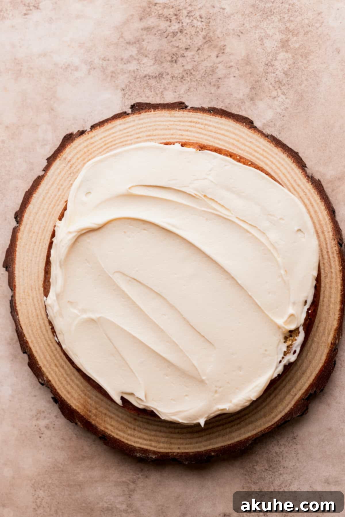 Rich Butterscotch Bliss 10 Frosting applied on top of the first cake layer.