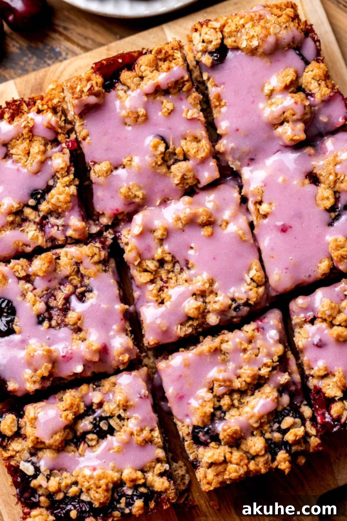 Classic Cherry Pie Bars 3 Close-up top view of freshly baked cherry pie bars in a square pan, showcasing the golden oatmeal crumble and glistening cherry filling.