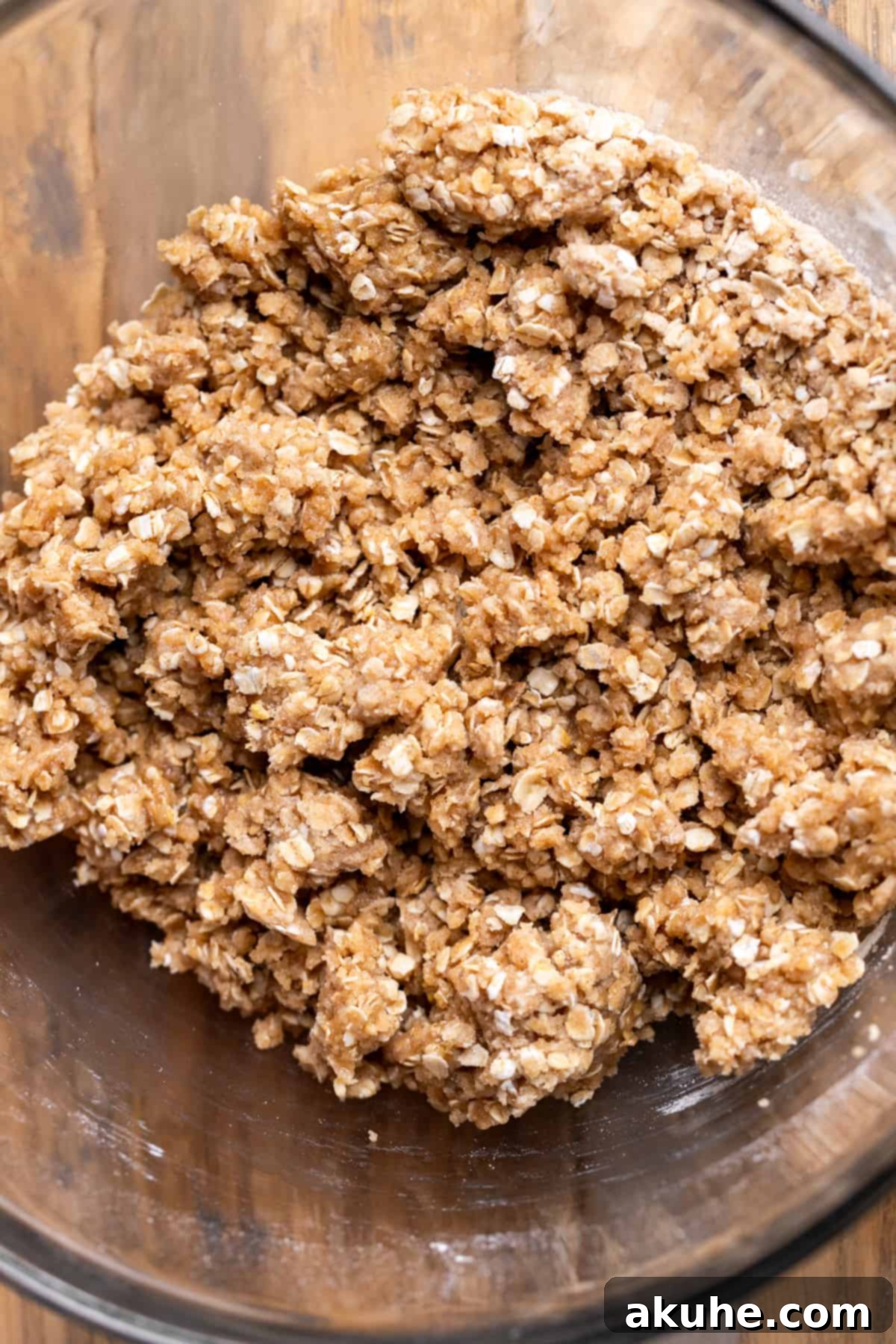 Classic Cherry Pie Bars 5 A bowl filled with golden-brown oatmeal cinnamon crumble mixture.