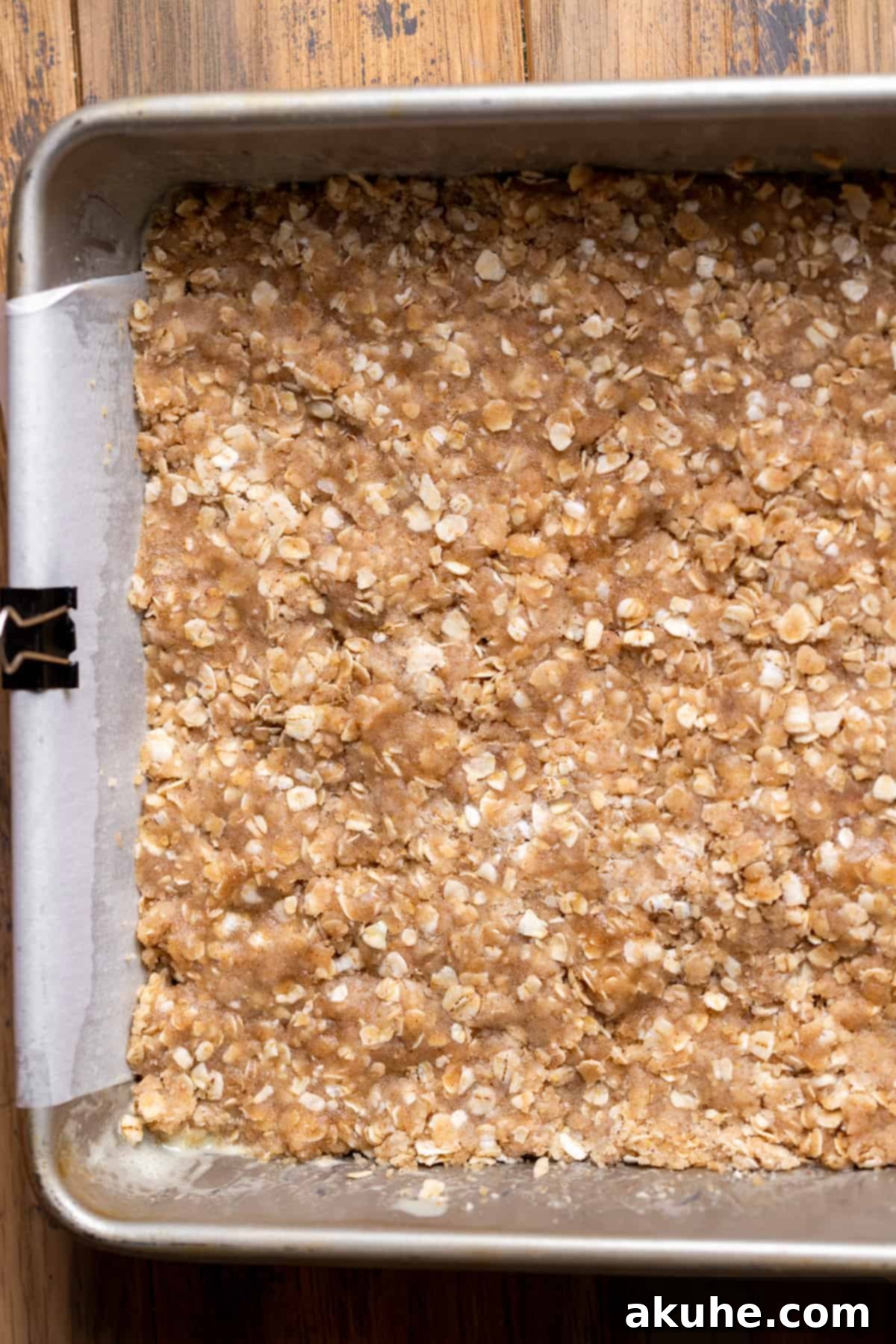 Classic Cherry Pie Bars 6 The oatmeal crumble base pressed into the bottom of a baking pan, ready for baking.