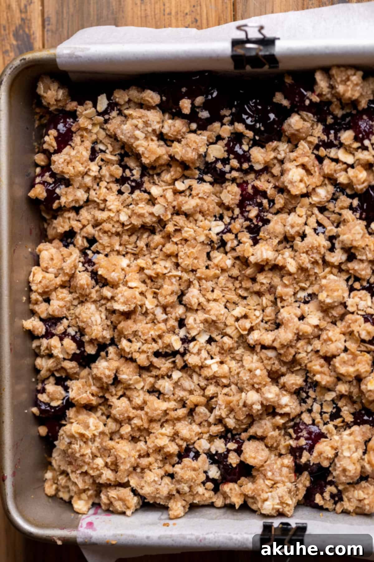 Classic Cherry Pie Bars 8 Close-up of cherry pie filling topped with a generous sprinkle of oatmeal crumble before final baking.