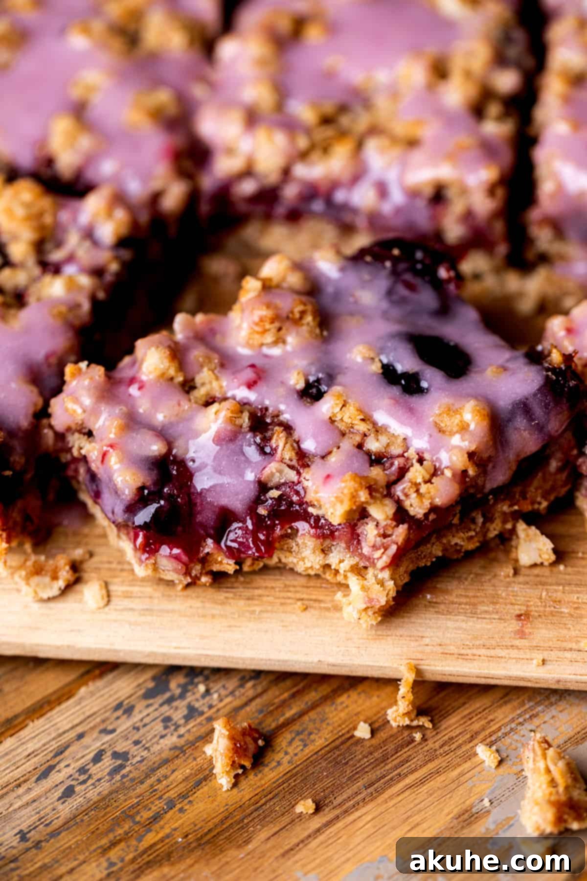 Classic Cherry Pie Bars 10 A cherry pie bar with a bite taken out of it, showcasing the layers of crumble and cherry filling.