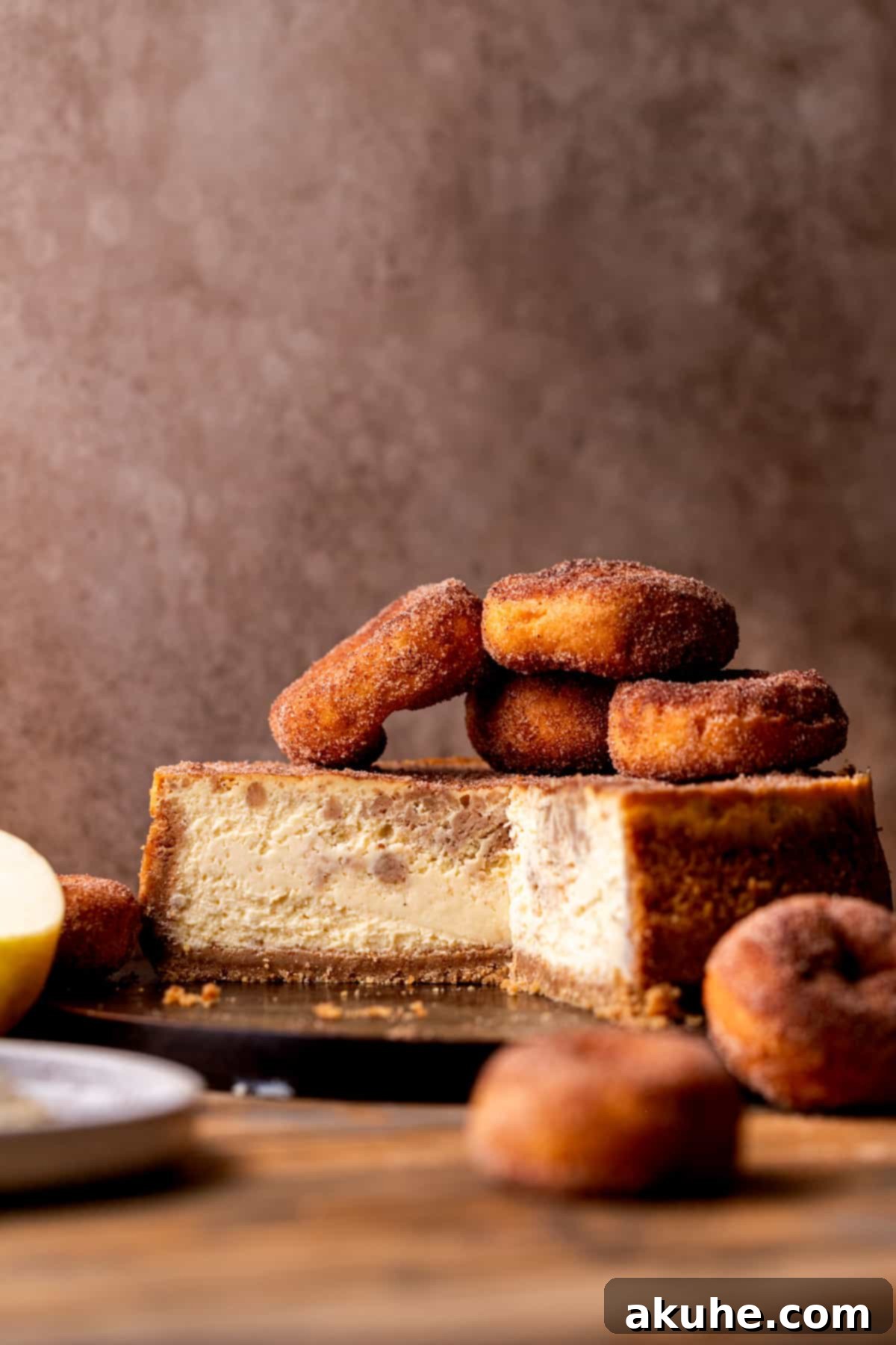 Spiced Apple Cider Cheesecake 2 Apple cider cheesecake split open on a board.