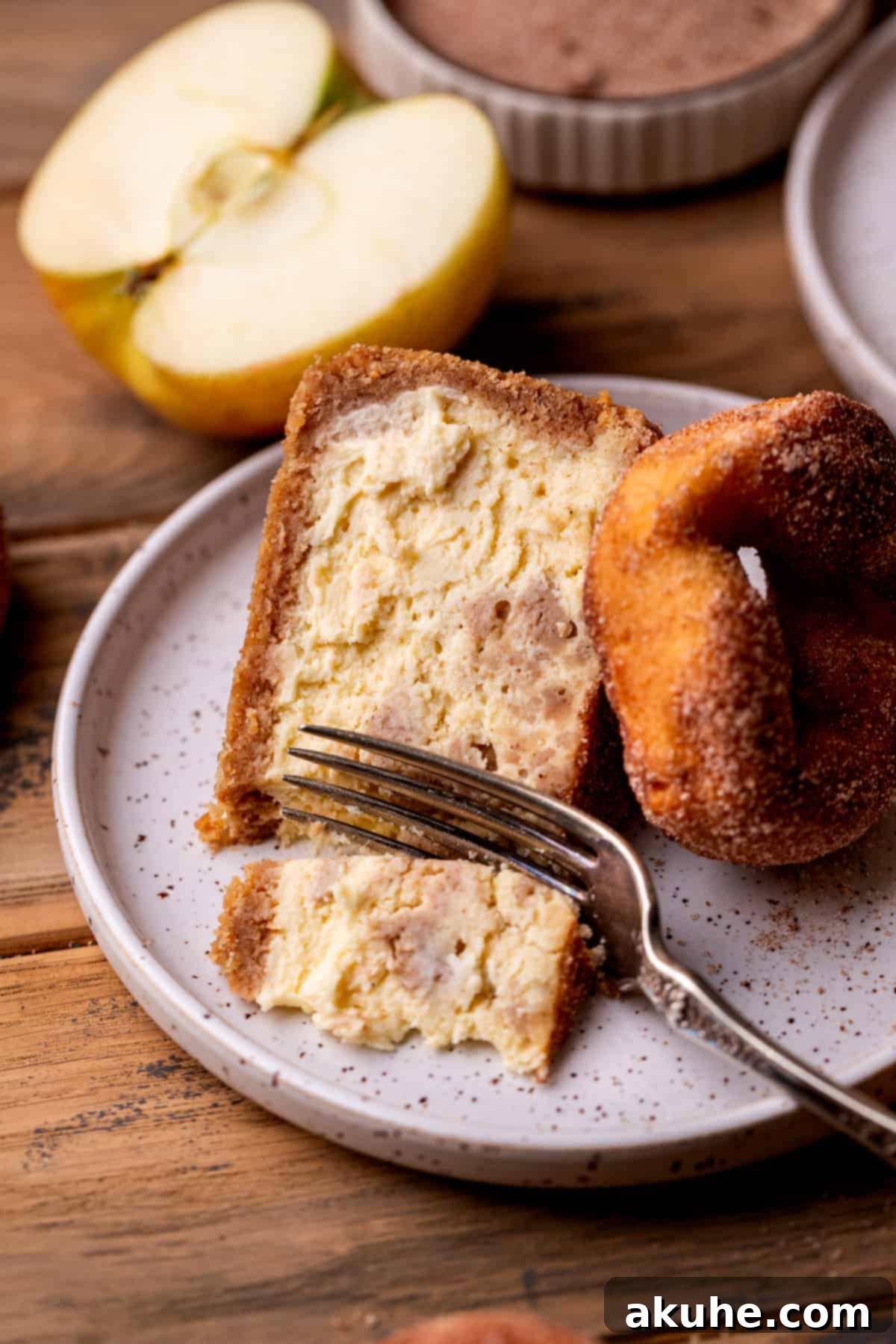 Spiced Apple Cider Cheesecake 11 Fork inserted into a slice of cheesecake.
