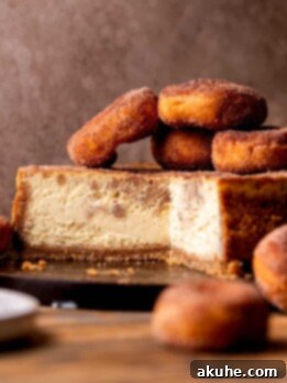 Spiced Apple Cider Cheesecake 12 Apple cider cheesecake split open on a board.