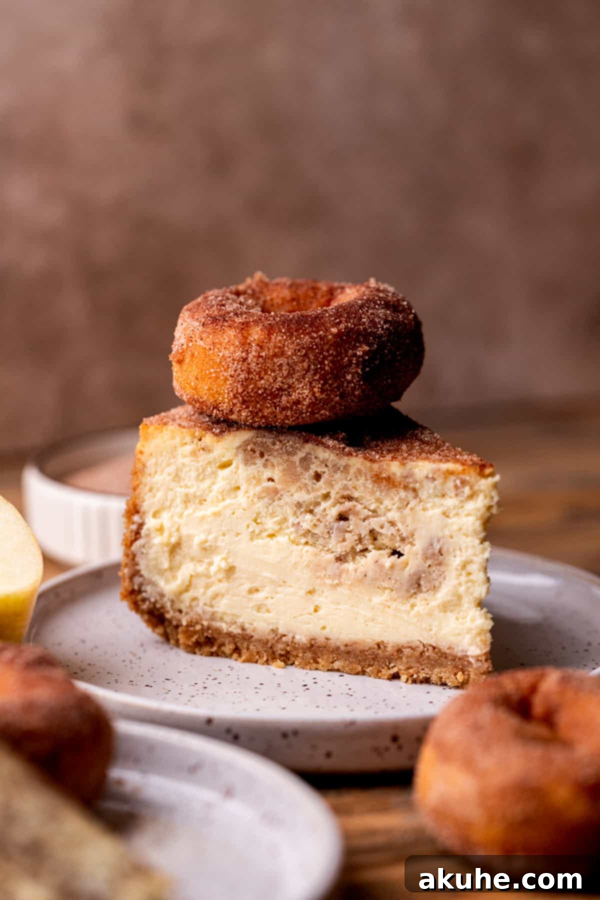 Spiced Apple Cider Cheesecake 3 Slice of apple cider cheesecake on a plate.