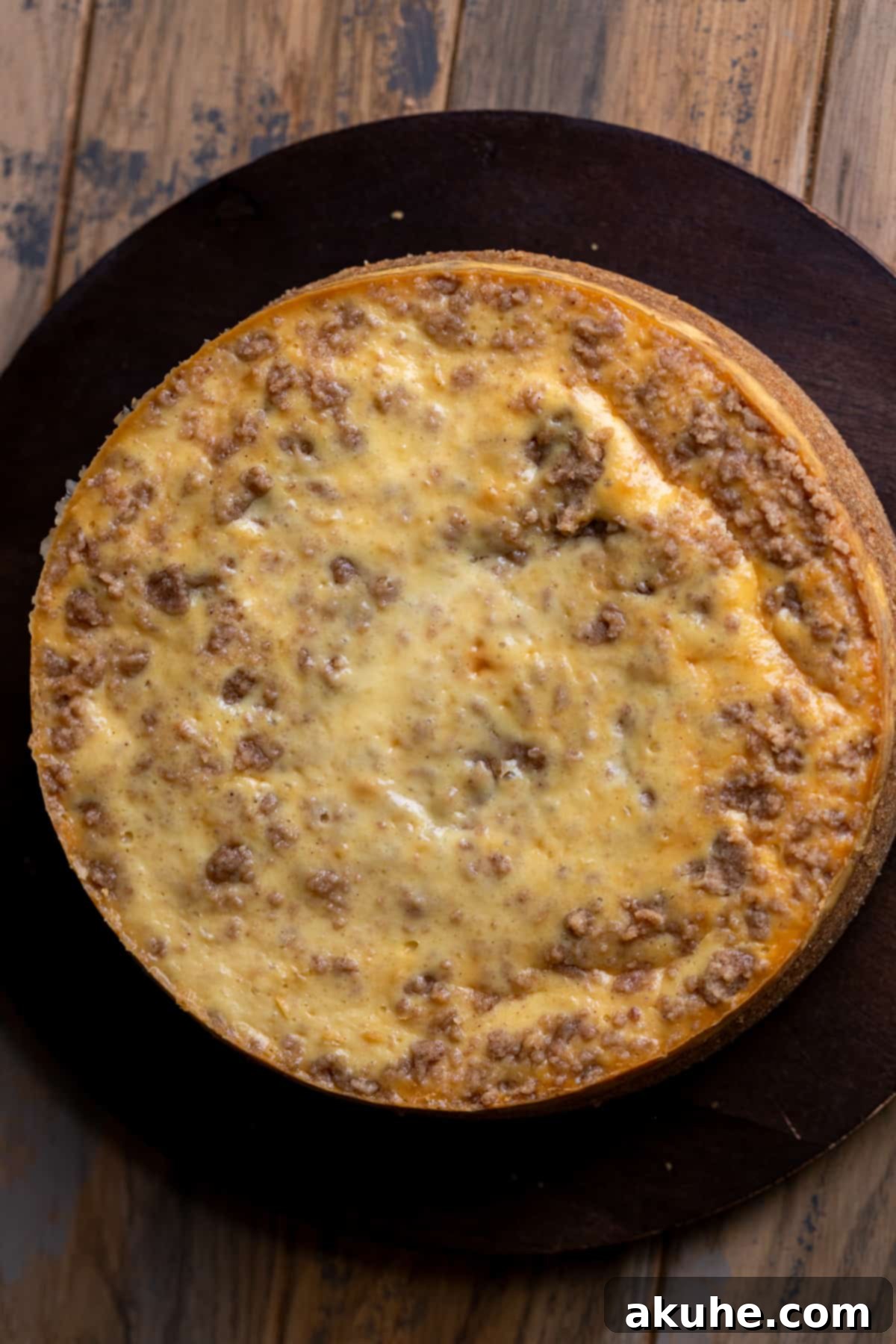 Spiced Apple Cider Cheesecake 9 Baked cheesecake on a board.