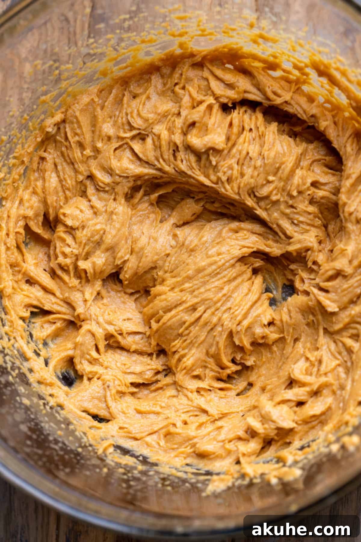 Spiced Pumpkin Chocolate Chip Cookies 4 Wet ingredients in a glass bowl, featuring melted butter, sugars, pumpkin puree, vanilla, and egg yolk.