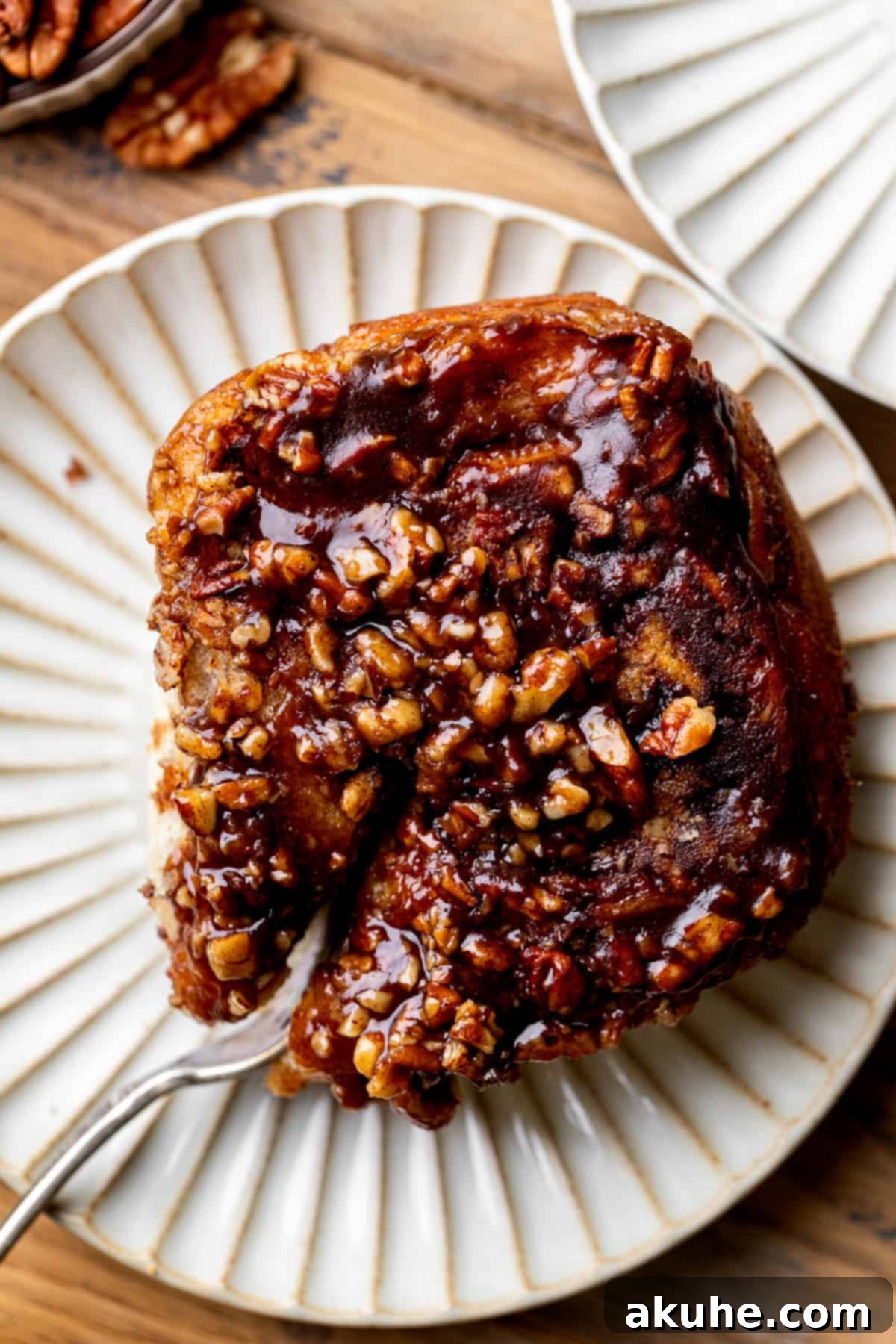Irresistible Caramel Buns 3 One bun on plate with a fork inserted.
