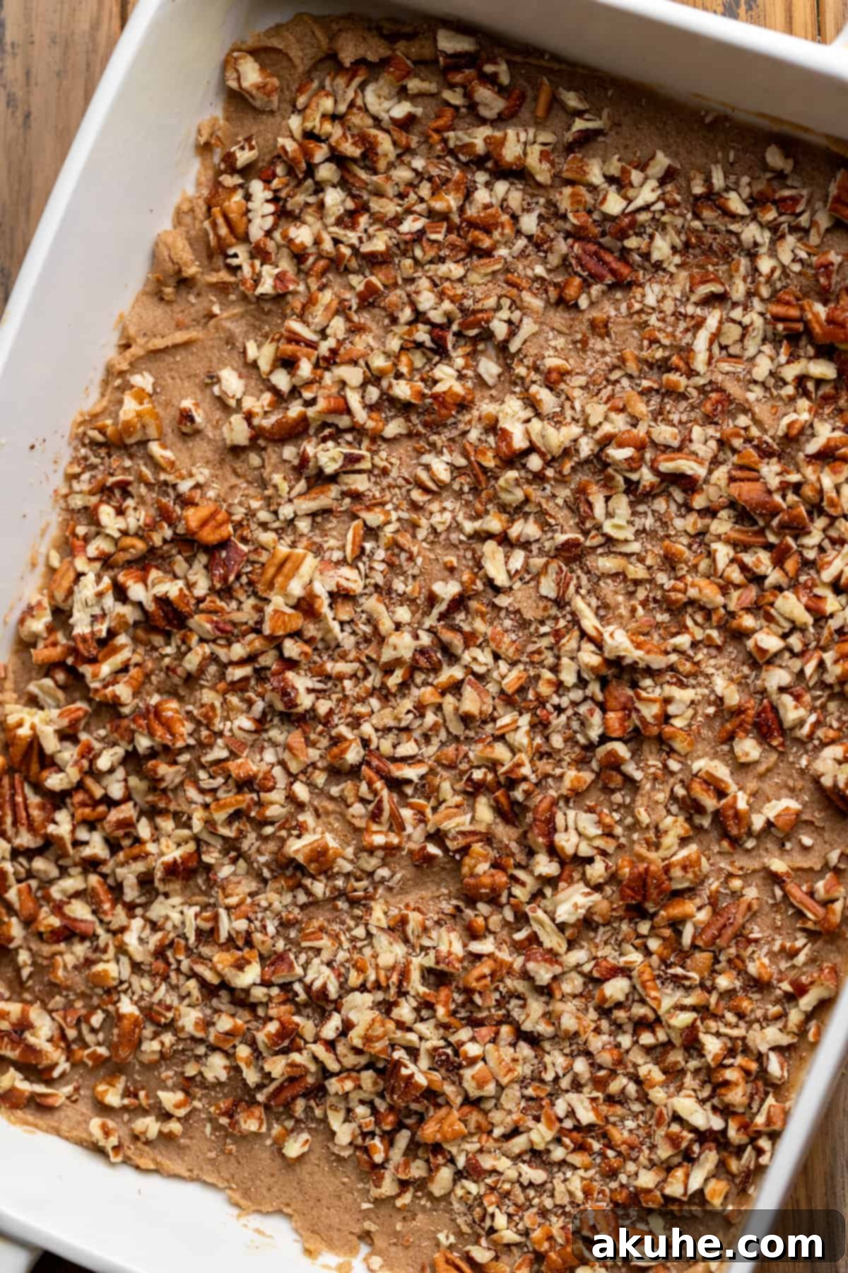 Irresistible Caramel Buns 7 Sticky topping and pecans in a pan.