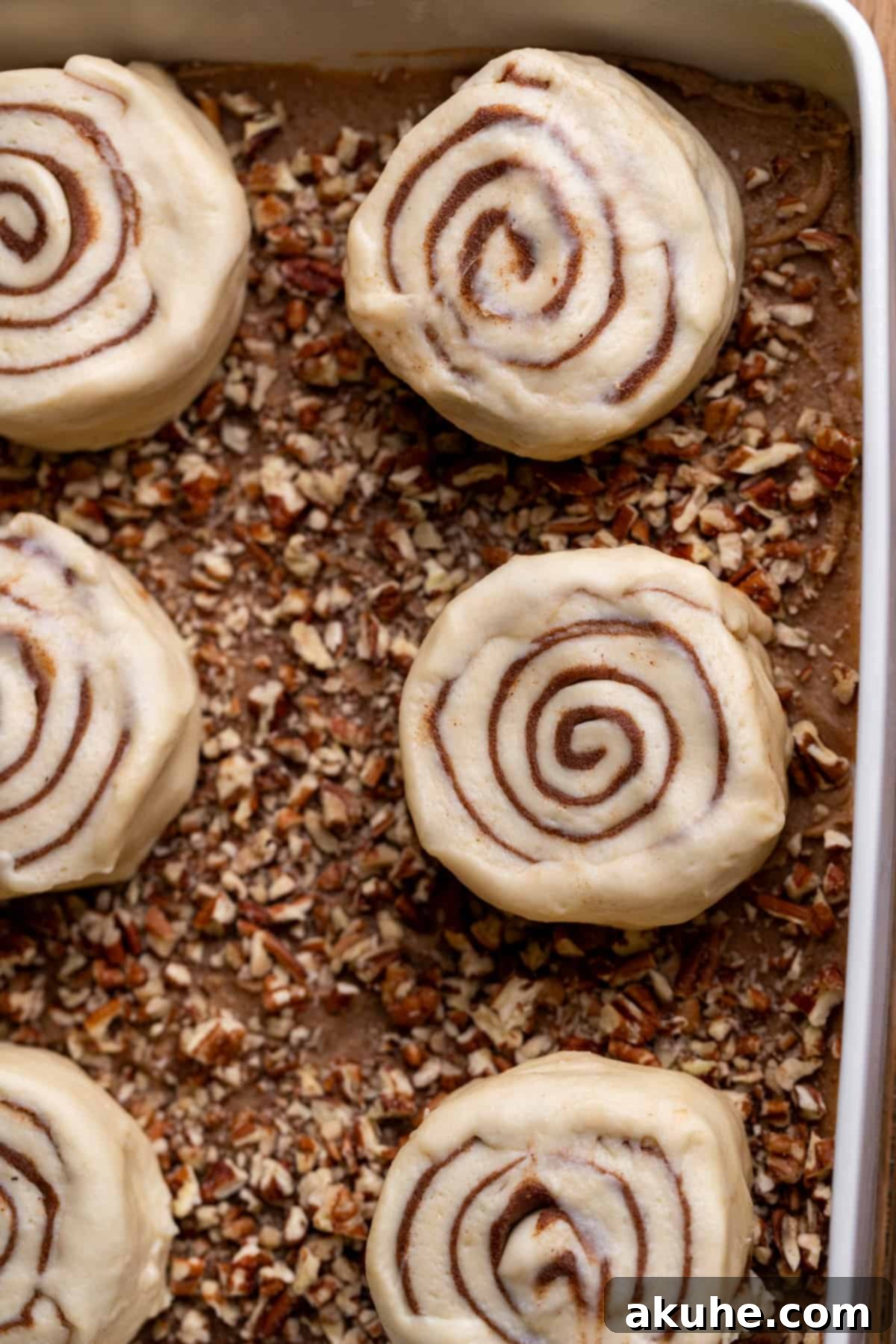 Irresistible Caramel Buns 10 Raw cinnamon rolls on top of the sticky topping.