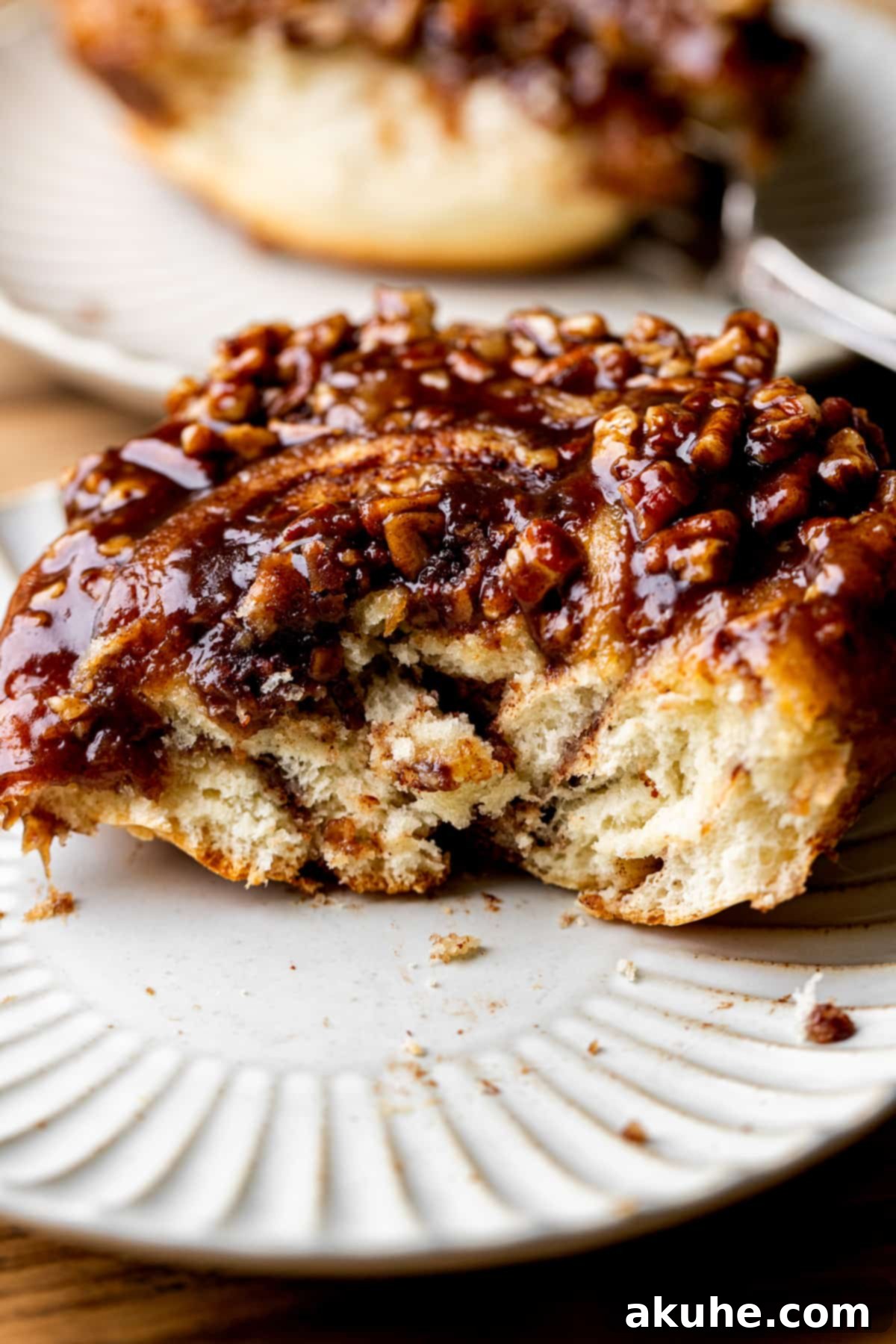 Irresistible Caramel Buns 12 Side view of giant sticky bun on a plate.