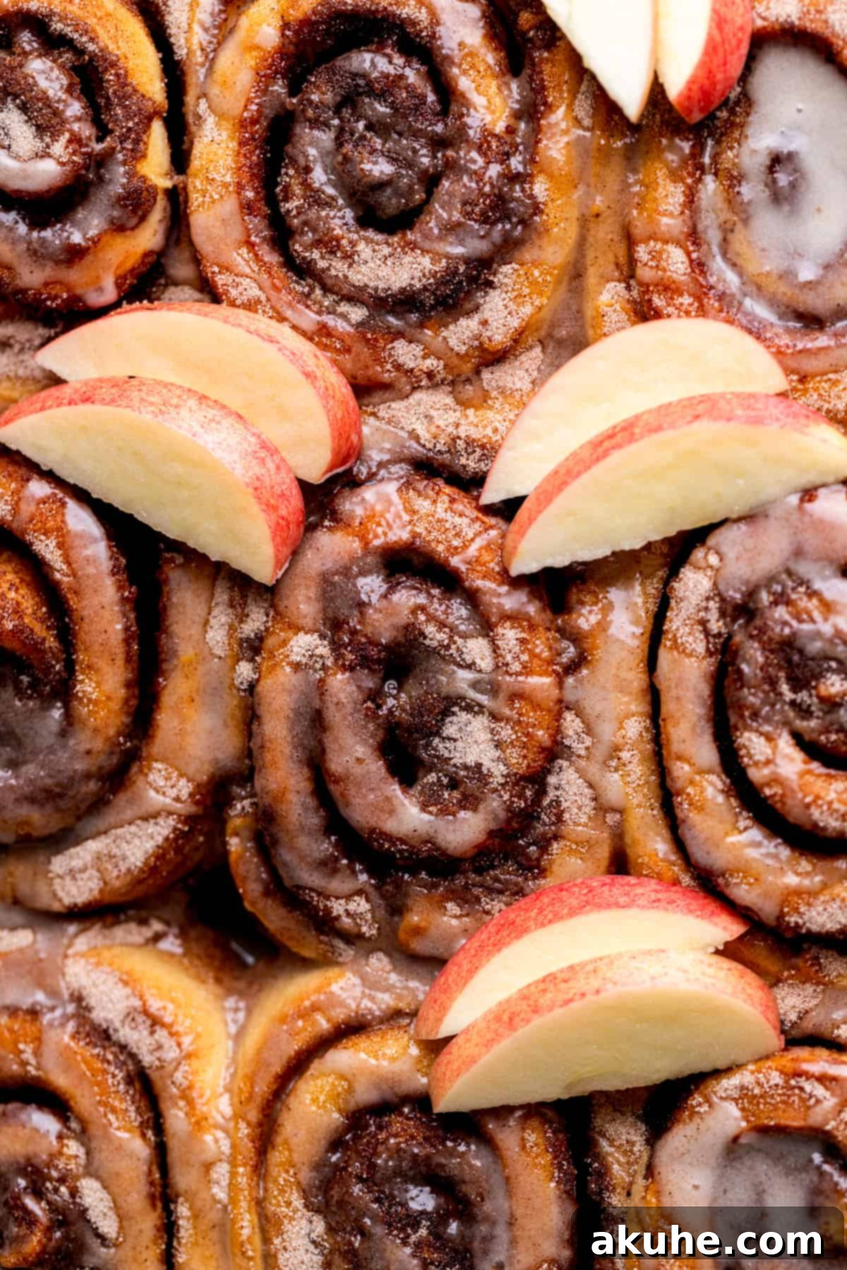 Spiced Apple Cider Cinnamon Rolls 2 Golden brown apple cider cinnamon rolls artfully arranged in a baking pan, ready to be glazed.