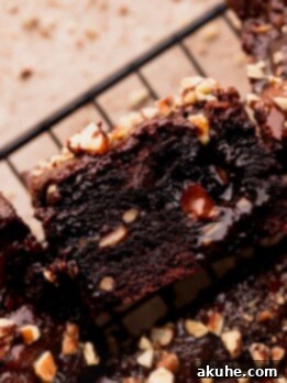 Pecan Caramel Fudge Brownies 13 One turtle brownie on its side, highlighting its fudgy texture and caramel filling.