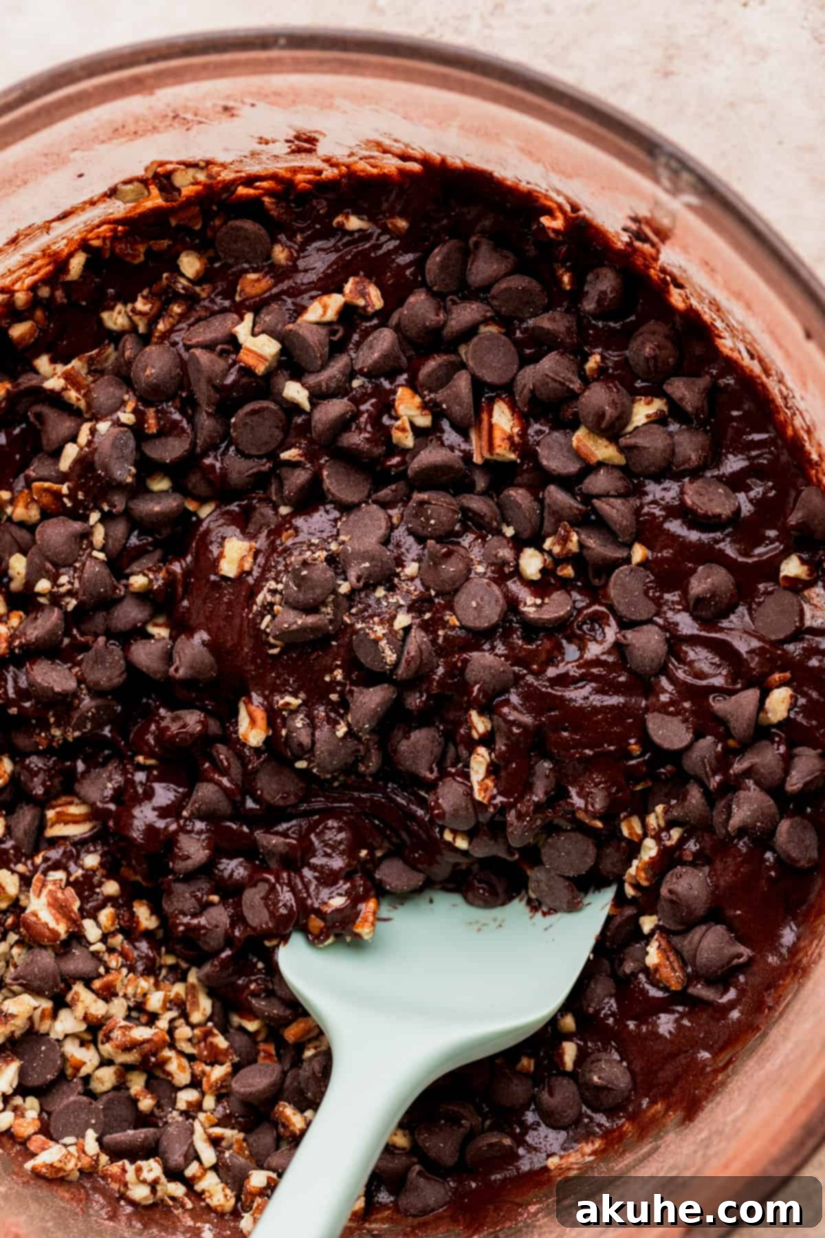 Pecan Caramel Fudge Brownies 5 Brownie batter with chocolate chips and chopped pecans folded in, ready for baking.
