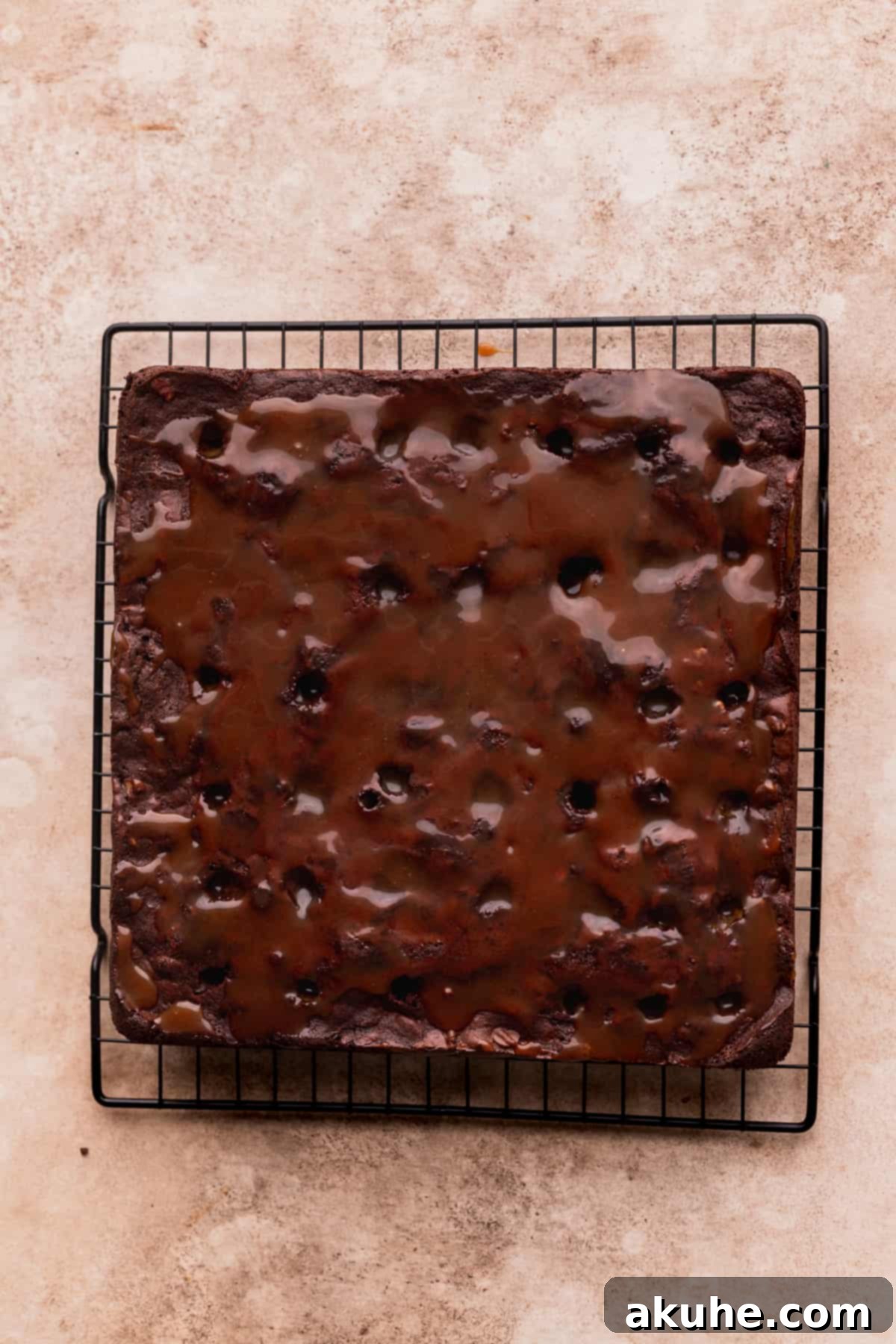 Pecan Caramel Fudge Brownies 10 Salted caramel generously poured over poked holes on brownies, with pecans sprinkled on top.