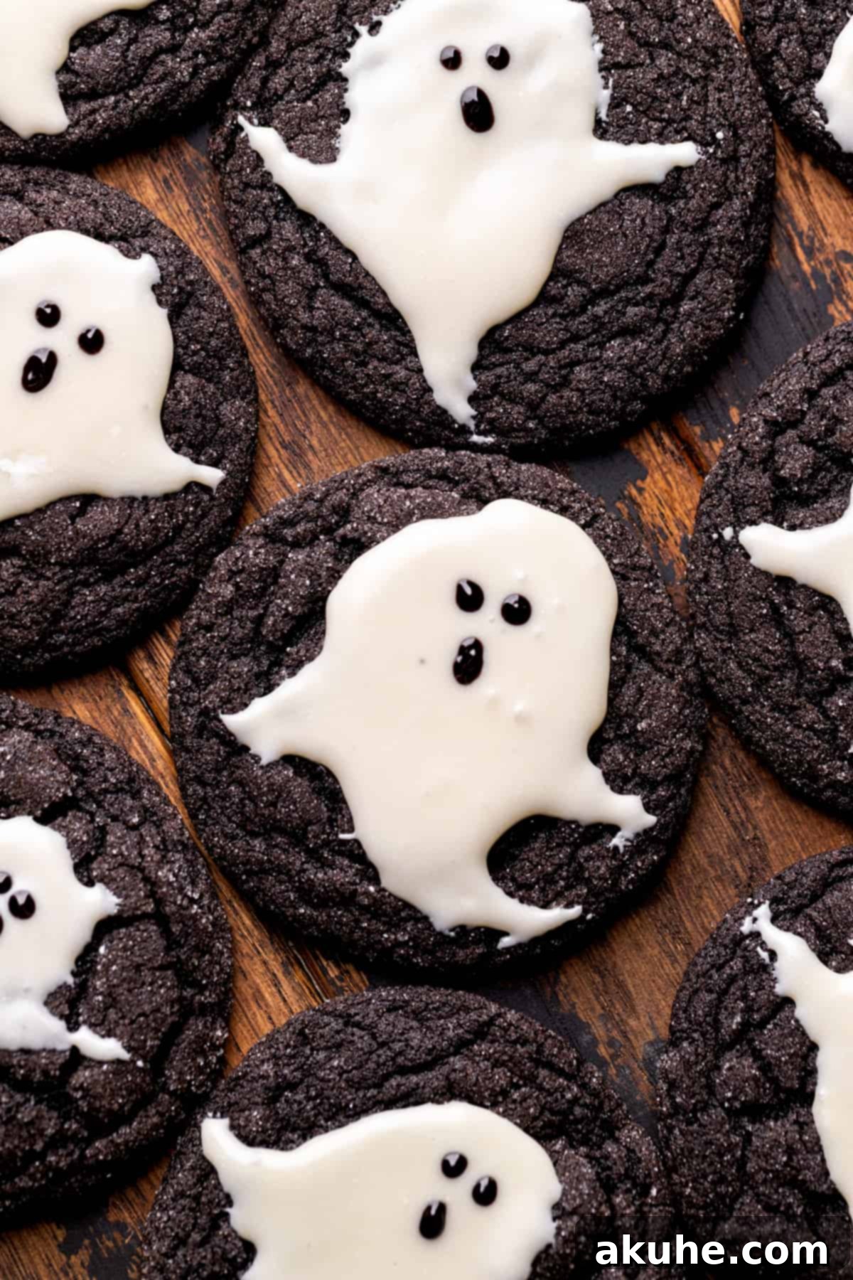 Top view of ghost cookies, showcasing their black cocoa base and white chocolate ghosts, arranged invitingly on a platter.