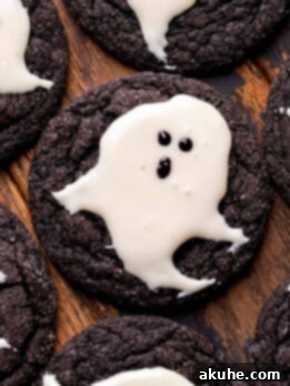 Top view of ghost cookies on a dark background.