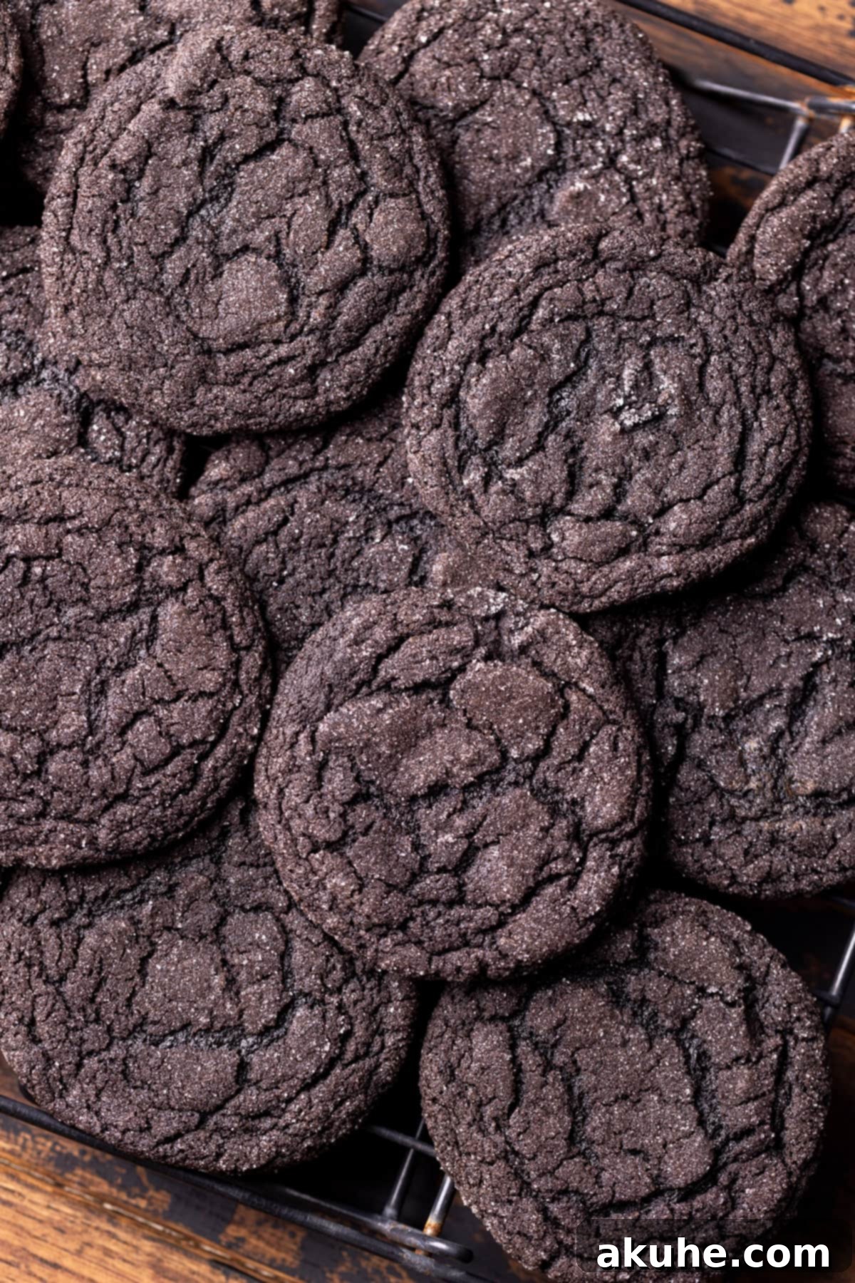 Freshly baked black cocoa cookies cooling on a wire rack.