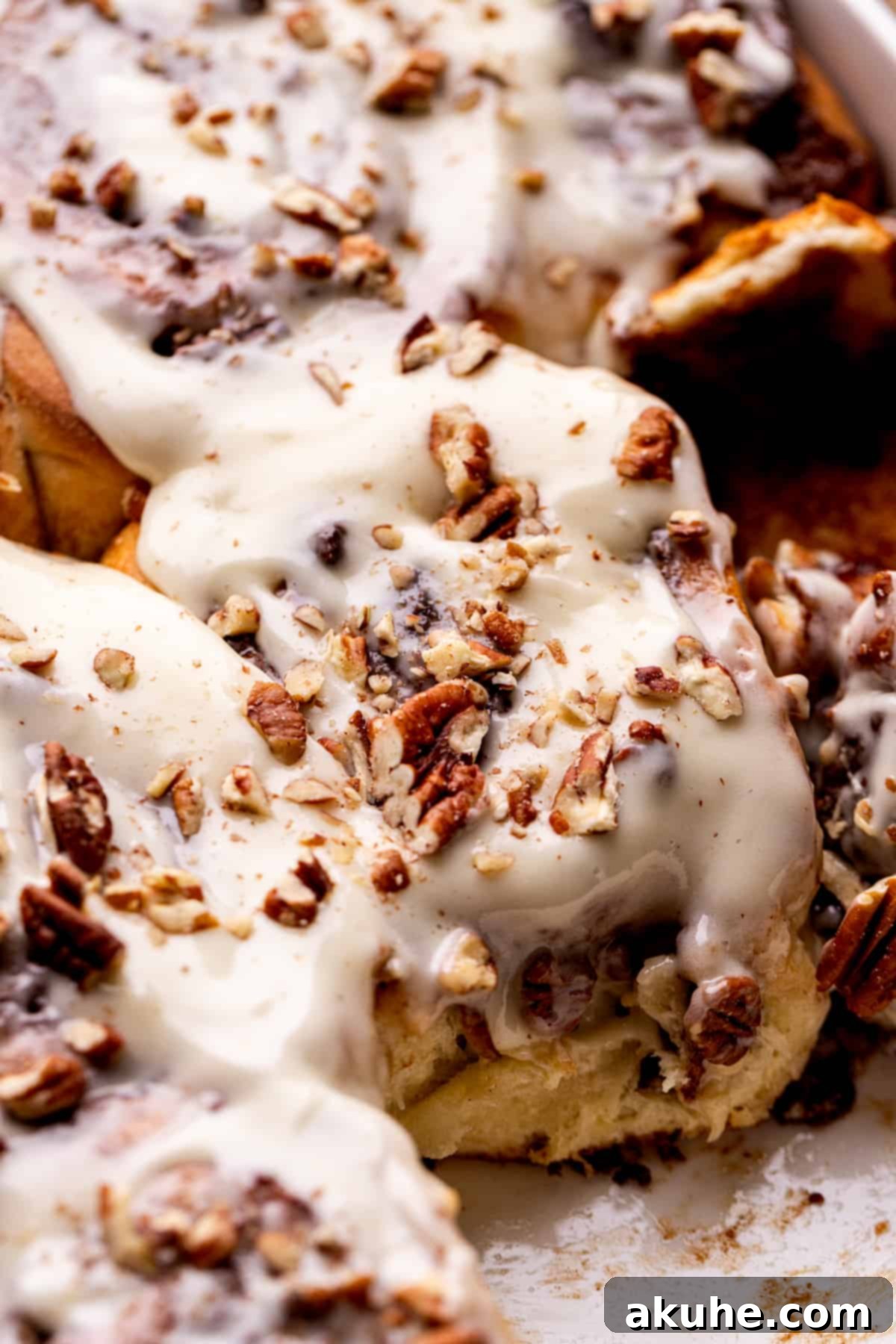 Side view of a batch of pecan pie cinnamon rolls, showing their height and layered filling.