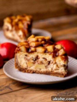 Spiced Apple Pie Cheesecake 12 Side view of apple pie cheesecake on a plate.