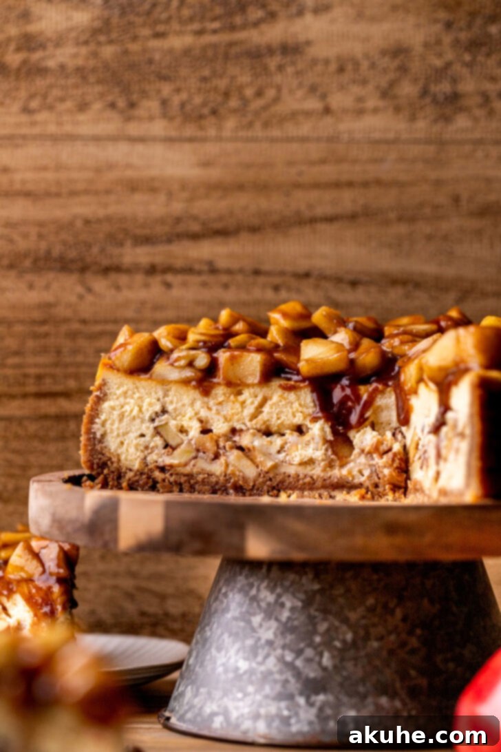 Spiced Apple Pie Cheesecake 3 Close-up side view of the Apple Pie Cheesecake, highlighting its inviting texture and the generous apple topping.