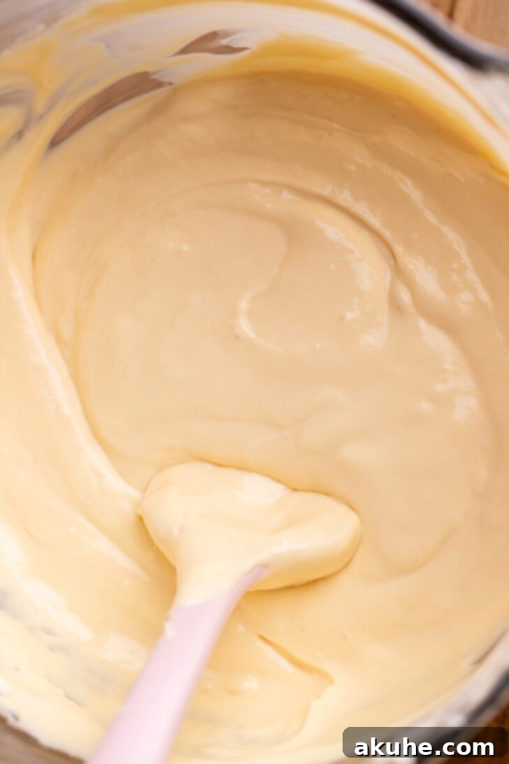 Spiced Apple Pie Cheesecake 4 Caramel cheesecake batter in a bowl, showing its creamy texture.