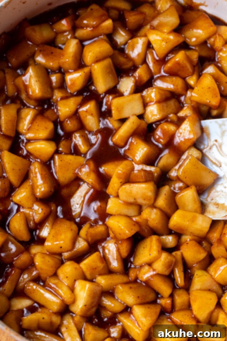 Spiced Apple Pie Cheesecake 5 Thickened apple pie filling simmering in a pan.