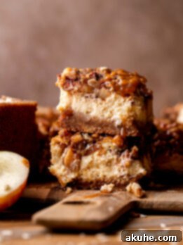 Spiced Caramel Apple Cheesecake Bars 13 Stack of two caramel apple cheesecake bars.