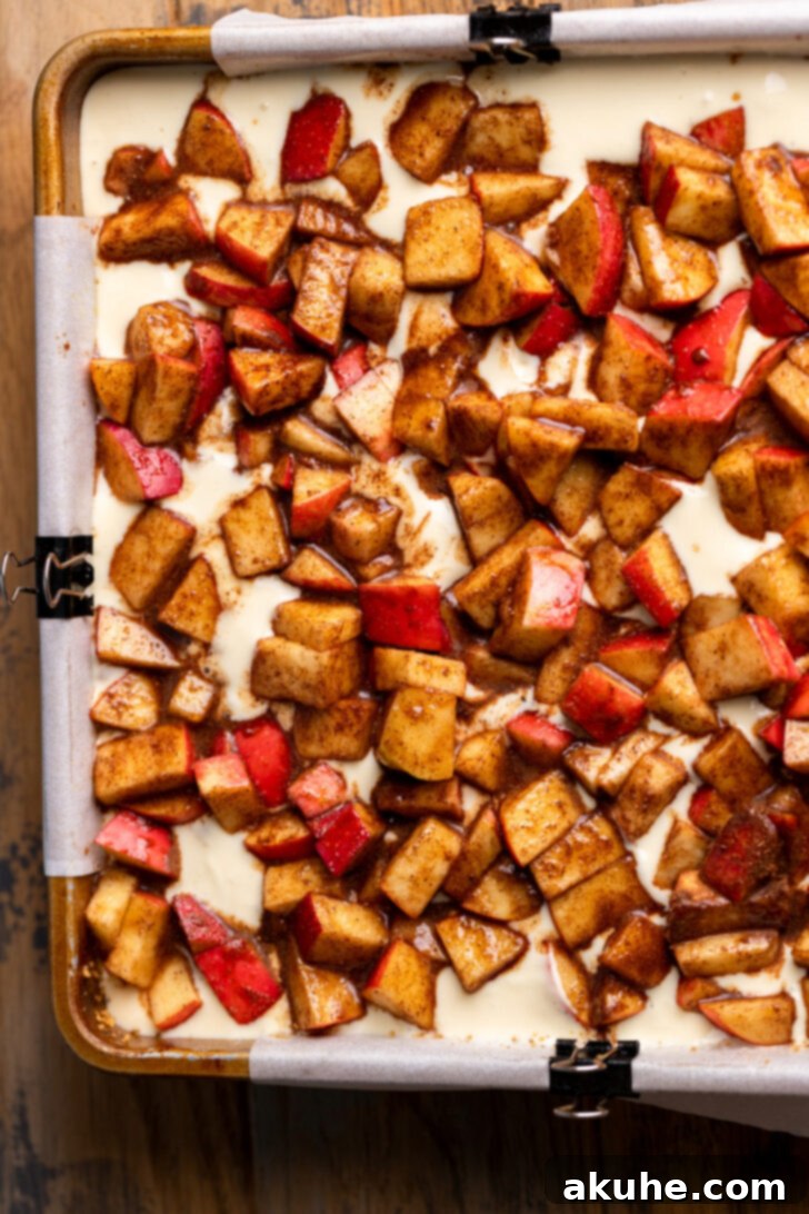 Spiced Caramel Apple Cheesecake Bars 8 Spiced apples spread evenly over the cheesecake batter.