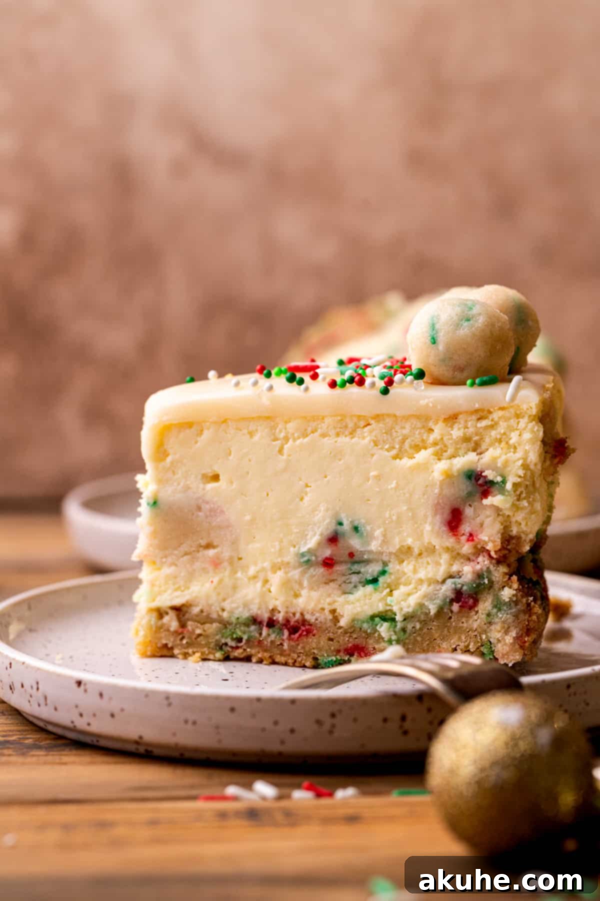 Sugar Cookie Dream Cheesecake 12 A stunning side profile of a sugar cookie cheesecake slice, standing upright on a plate, showcasing its beautiful layers and texture.