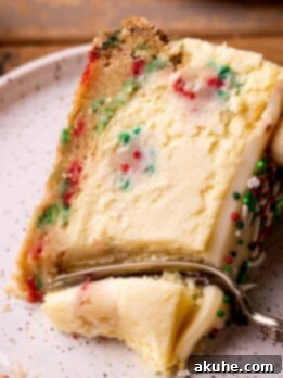 Sugar Cookie Dream Cheesecake 14 Fork inserted into sugar cookie cheesecake.