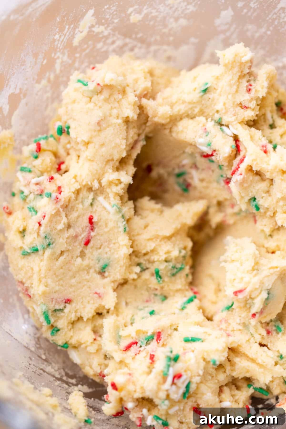 Sugar Cookie Dream Cheesecake 4 Sugar cookie dough mixture in a clear glass bowl, ready for the next step.