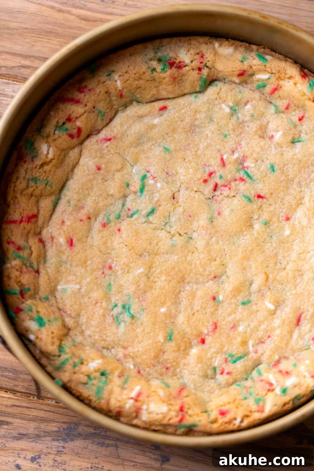 Sugar Cookie Dream Cheesecake 6 A perfectly golden-brown baked sugar cookie crust resting in a springform pan.